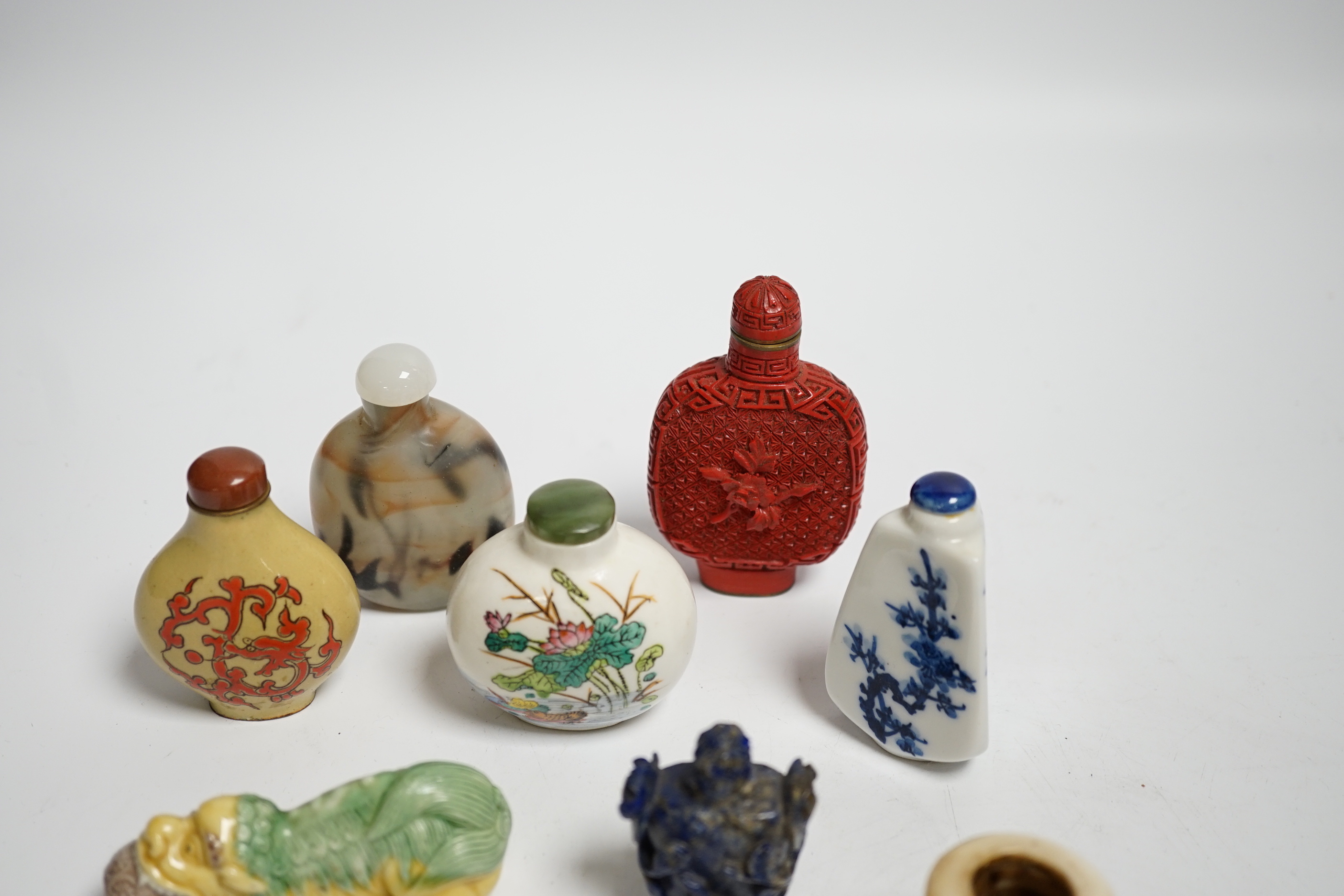 Seven various snuff bottles including simulated cinnabar lacquer, lapis lazuli, ceramic etc. together with a pottery vessel and another bone (9)